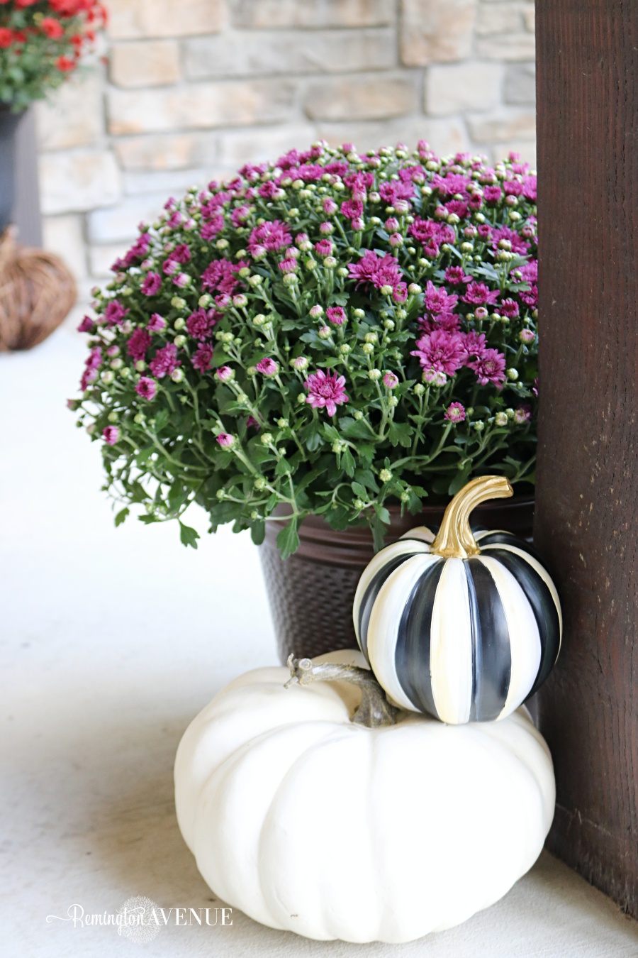 copper & jewel toned fall front porch with bold black and white patterns