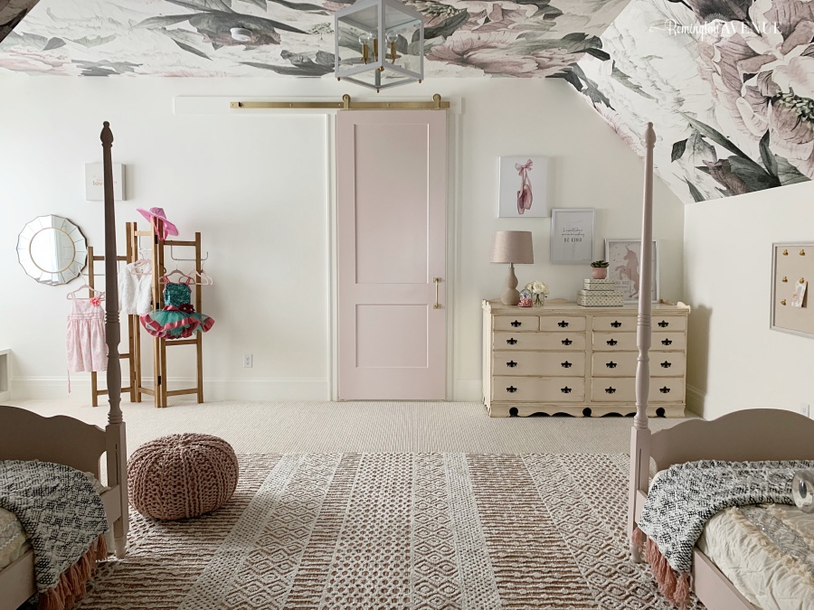 Shared girls bedroom with floral wallpaper